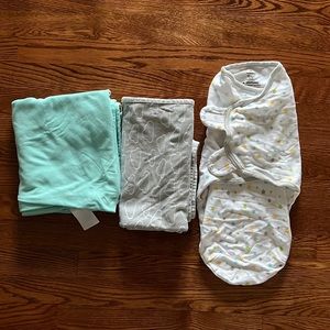 Two swaddle blankets and a swaddle